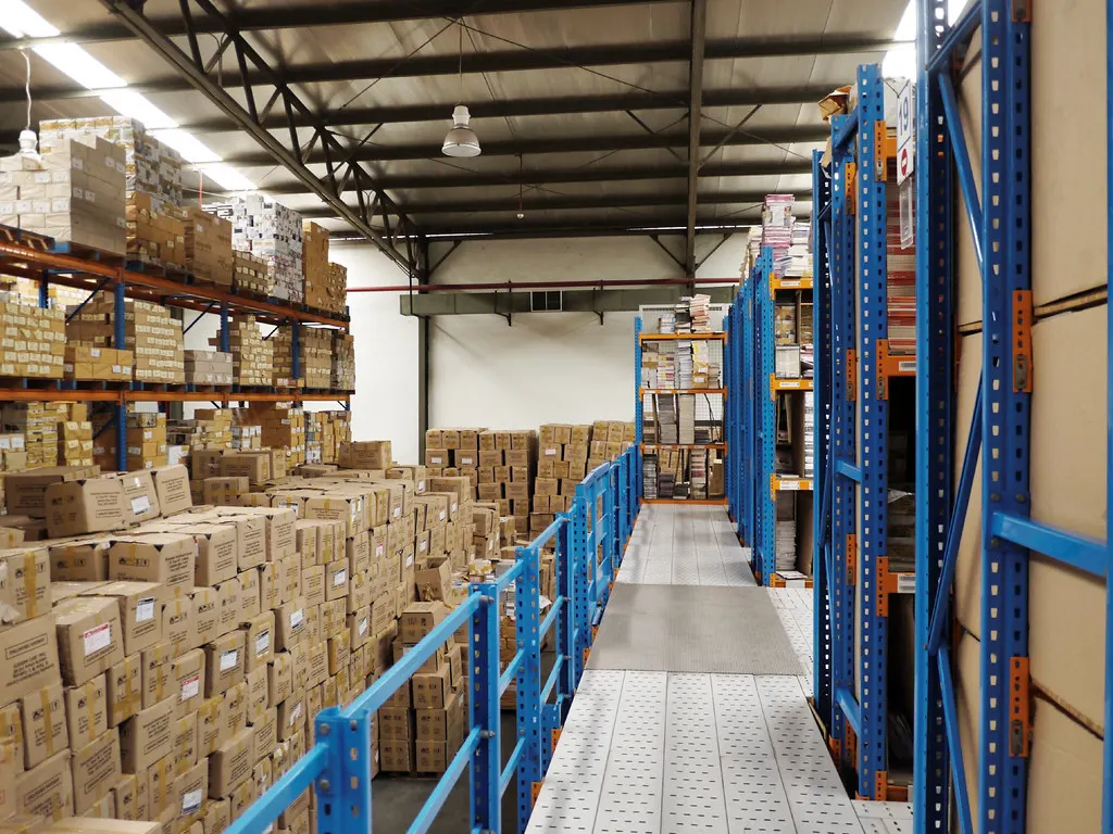 Warehouse aisle with pallet racking stocked with boxes